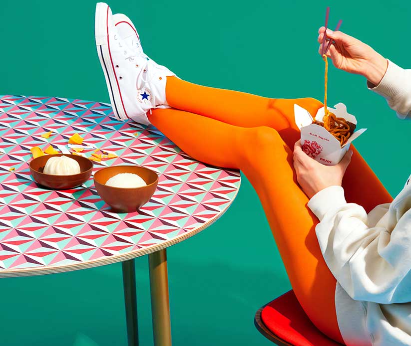 Woman Eating with Feet up on the Table