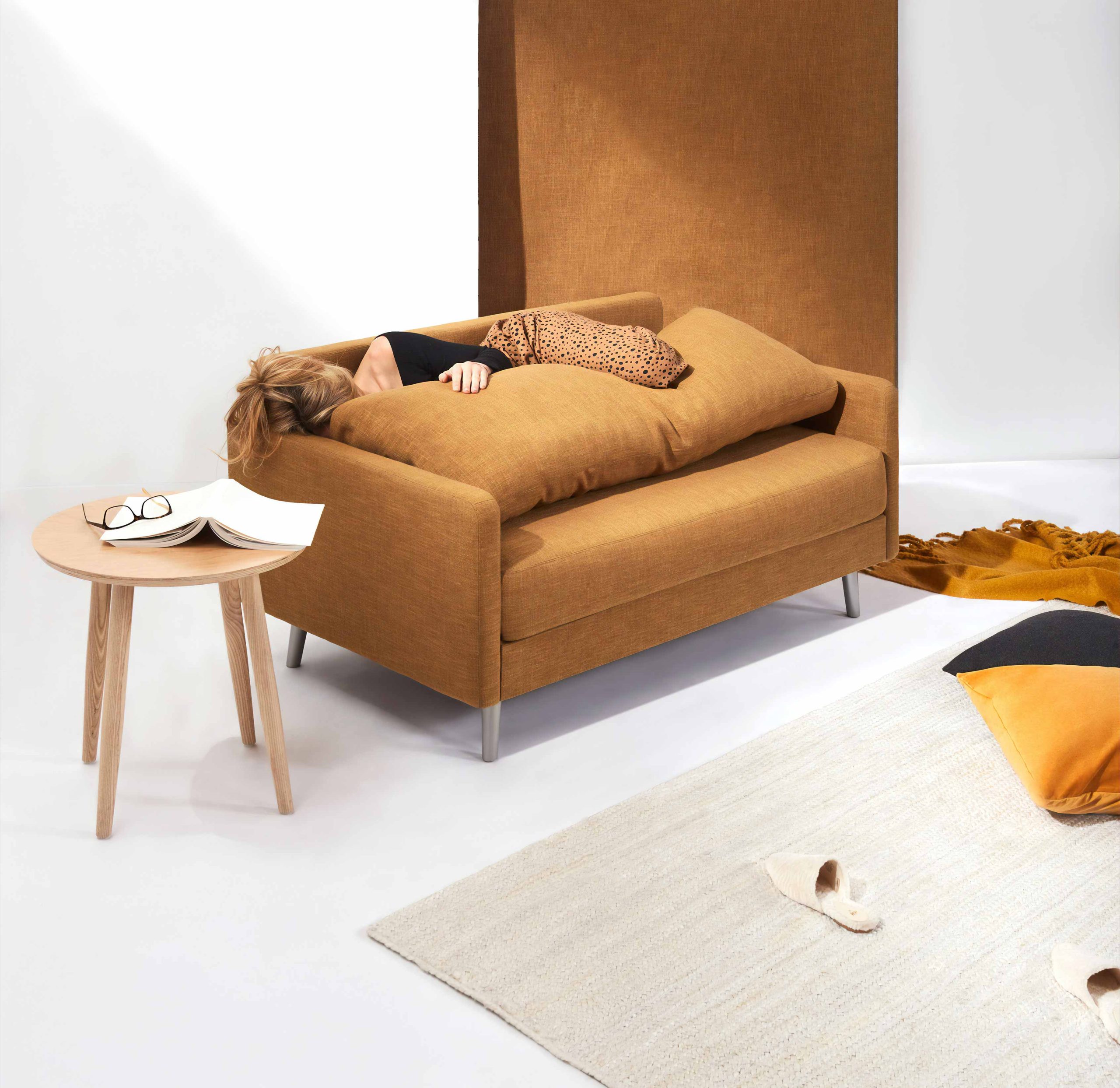 Woman Laying on Brown Sofa 1